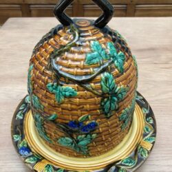 majolica pottery Minton Stilton cheese bell in the shape of a beehive decorated with blackberry branches and fruit with heavier branches forming the finial.